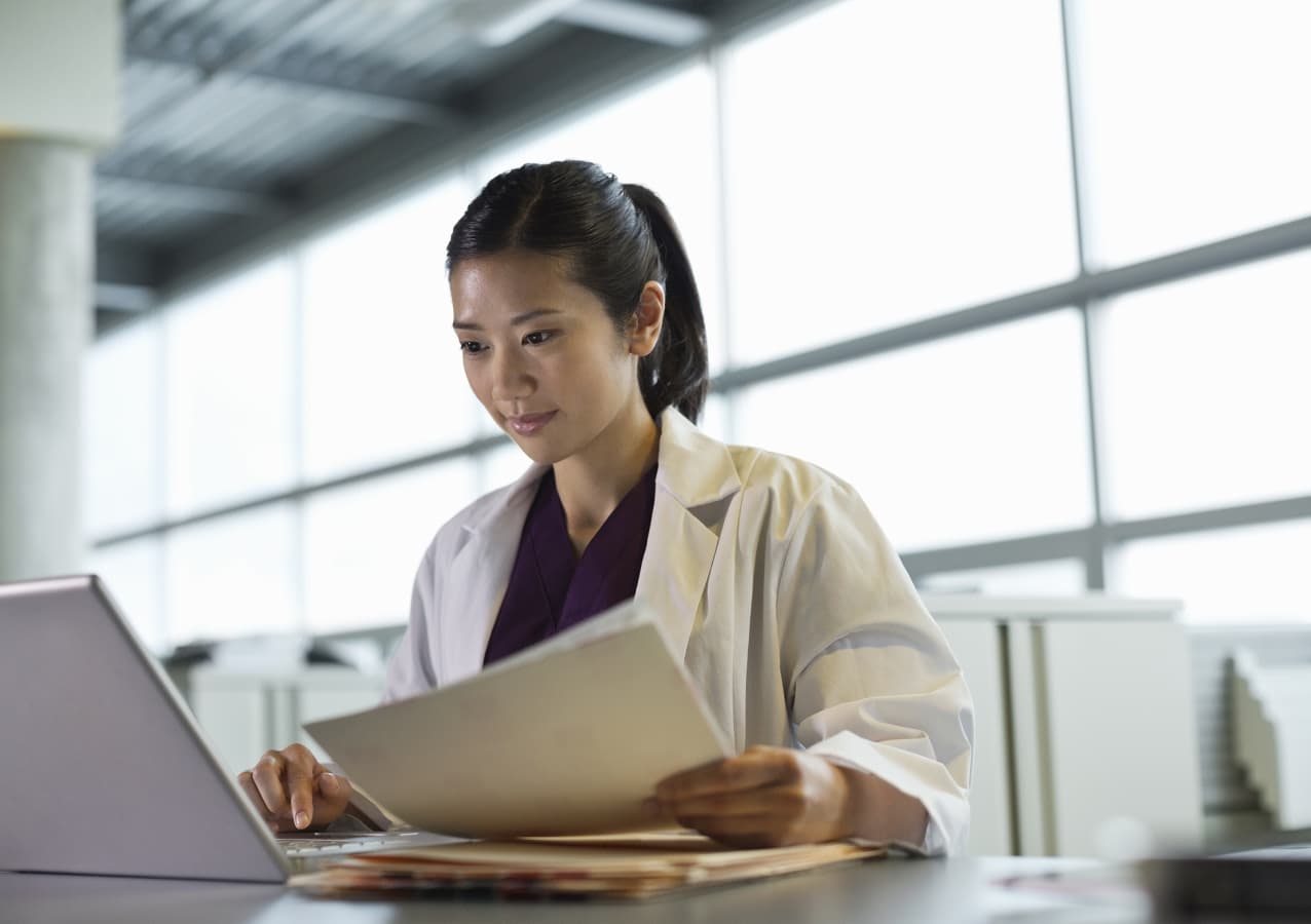 Clinician keeping current on her laptop