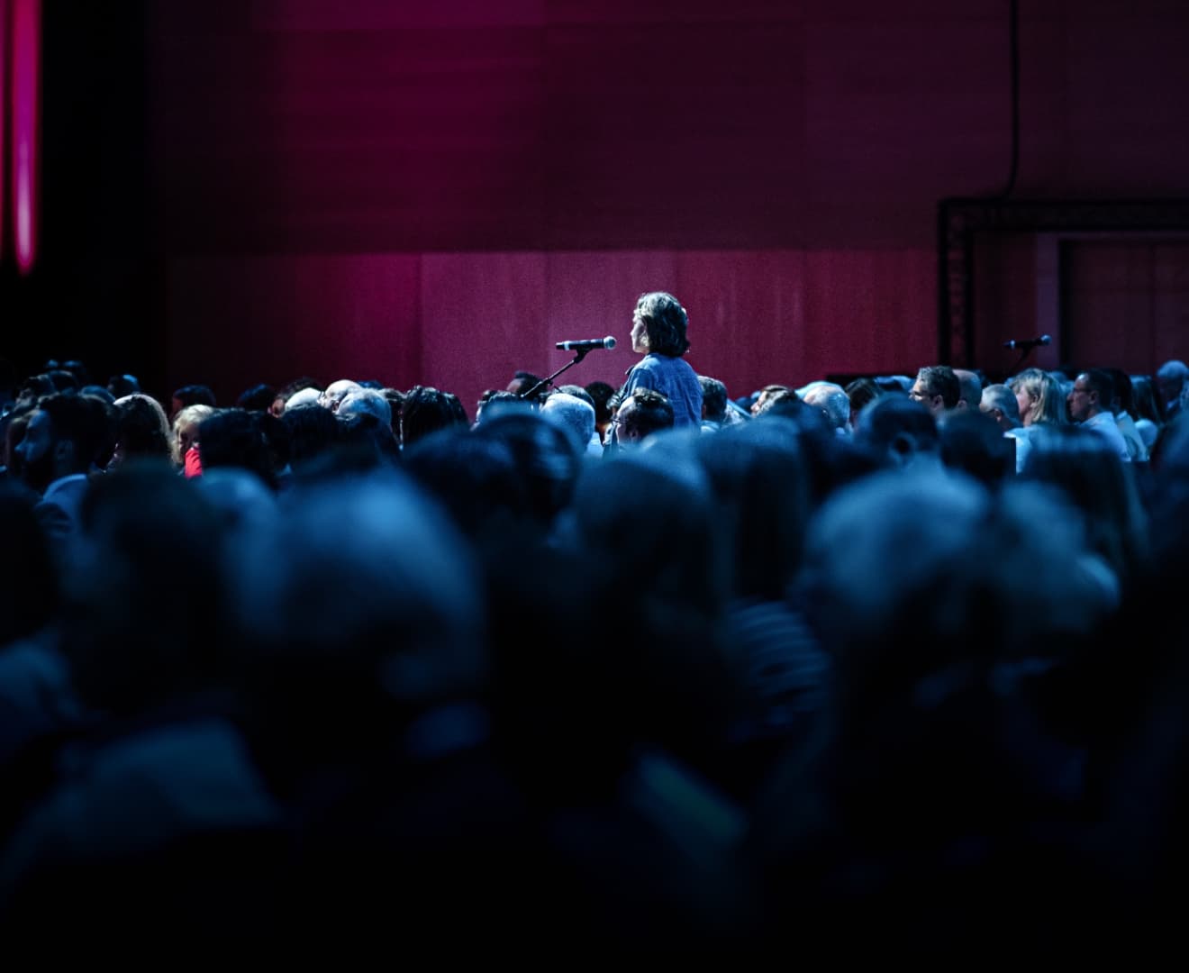 Attendee speaking at an microphone at a live HMP Global event